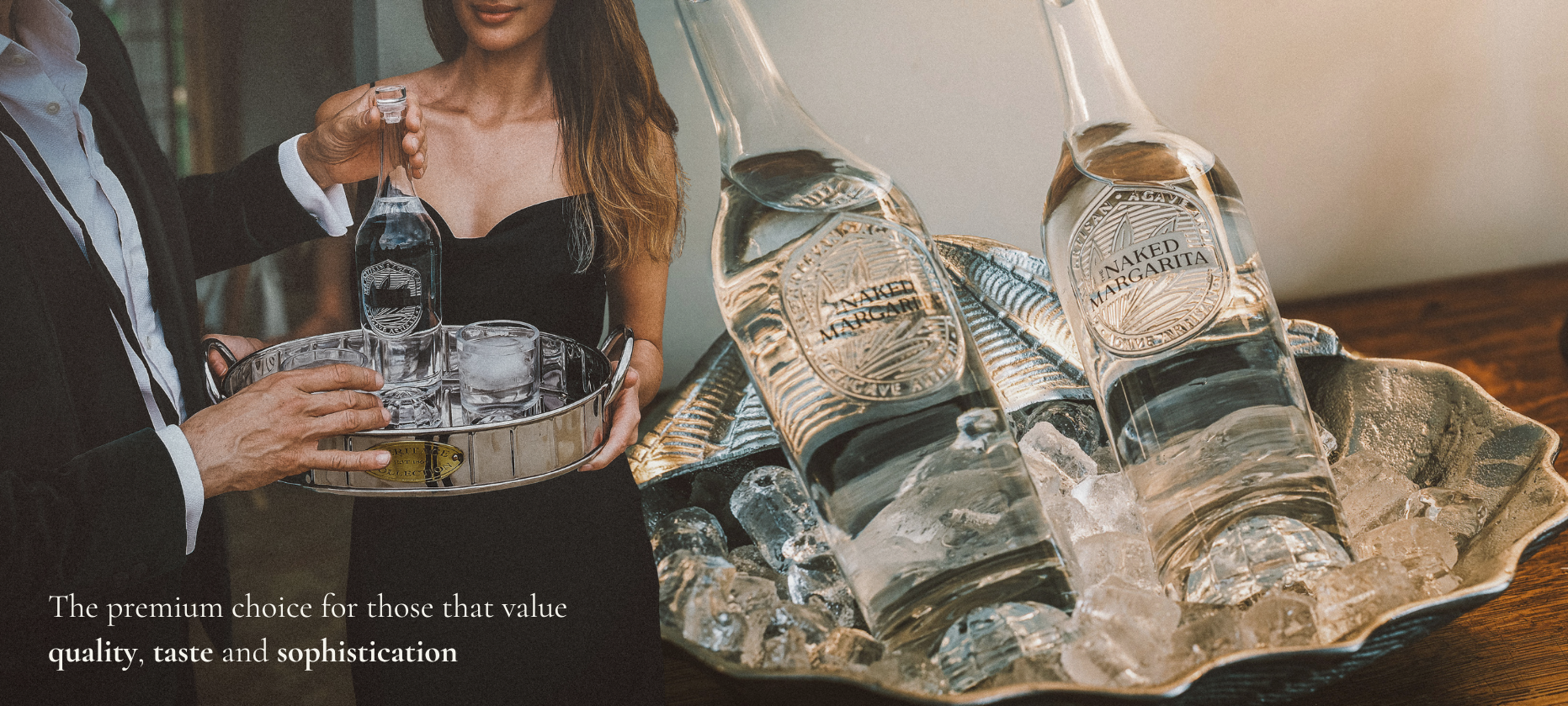 A lifestyle scene showing a bartender in a black tuxedo holding a silver tray with a clear glass bottle, alongside two large clear bottles on a decorative silver tray filled with ice. The setting appears warm and upscale, with a blurred background and promotional text in the lower left.
